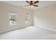 Bright empty bedroom featuring double windows that let in natural light and white carpet flooring at 6042 Legacy Cir, Charlotte, NC 28277