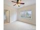 Bedroom with a ceiling fan, double window that lets in natural light, and white carpet flooring at 6042 Legacy Cir, Charlotte, NC 28277