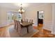 Charming dining room with hardwood floors, wainscotting and natural light from the window at 6042 Legacy Cir, Charlotte, NC 28277