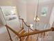 Staircase landing overlooking the foyer with hardwood floors, chandelier and abundant natural light at 6042 Legacy Cir, Charlotte, NC 28277