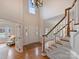 Welcoming foyer with hardwood floors, a front door, and staircase, providing a warm entry at 6042 Legacy Cir, Charlotte, NC 28277