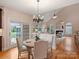 Breakfast nook with vaulted ceiling, hardwood floors, and open to the kitchen and living room at 6042 Legacy Cir, Charlotte, NC 28277