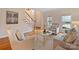 Elegant living room featuring a staircase, hardwood floors and natural light through large windows at 6042 Legacy Cir, Charlotte, NC 28277