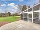 The cozy screened patio overlooks a sprawling green lawn with mature trees, offering a serene outdoor living space at 6042 Legacy Cir, Charlotte, NC 28277