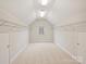 Large and bright storage space with white walls, carpet flooring, and shelving at 6042 Legacy Cir, Charlotte, NC 28277