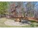 Landscaped backyard with fire pit and outdoor fitness area at 6361 Willow Farm Dr, Denver, NC 28037