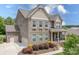 Side view of an elegant two-story brick home with attached garage and landscaped yard at 6361 Willow Farm Dr, Denver, NC 28037