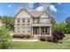 Charming two-story brick home featuring a well-manicured lawn and inviting front porch at 6361 Willow Farm Dr, Denver, NC 28037