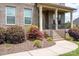 Inviting front porch featuring brick columns, decorative shrubs, and an address sign at 6361 Willow Farm Dr, Denver, NC 28037