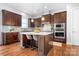 Modern kitchen with dark cabinetry, granite counters, and an island at 6361 Willow Farm Dr, Denver, NC 28037