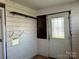 Small laundry area with door and shelves; requires updates at 649 Arch Dr, Rock Hill, SC 29730