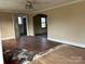 Hardwood floors, a ceiling fan, and partially removed carpet at 649 Arch Dr, Rock Hill, SC 29730