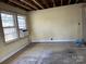 Empty living room with exposed beams, window, and tile floor. Needs renovation at 649 Arch Dr, Rock Hill, SC 29730