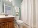 Bathroom featuring a single vanity, a toilet, and a shower with a white curtain at 712 English Tudor Ln, Charlotte, NC 28211