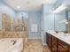 Bathroom with glass shower, soaking tub, and double vanity at 712 English Tudor Ln, Charlotte, NC 28211