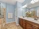 Bathroom featuring a double sink vanity and glass-enclosed shower at 712 English Tudor Ln, Charlotte, NC 28211