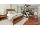 Bedroom with hardwood floors, large bed, shelving and home office set up at 712 English Tudor Ln, Charlotte, NC 28211