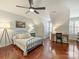 Bedroom featuring hardwood floors, a comfortable bed, and a writing desk at 712 English Tudor Ln, Charlotte, NC 28211