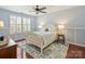 Bedroom featuring hardwood floors, a comfortable bed, shutters, and soft lighting at 712 English Tudor Ln, Charlotte, NC 28211