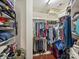 Walk-in closet with built-in shelving and hanging storage at 712 English Tudor Ln, Charlotte, NC 28211