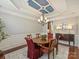 Bright dining room featuring a decorative tray ceiling, hardwood floors, and neutral wall paint at 712 English Tudor Ln, Charlotte, NC 28211