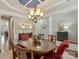 Dining room adjacent to the entry featuring a round wood table and a chandelier at 712 English Tudor Ln, Charlotte, NC 28211