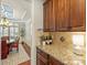 Close-up of granite countertops and wooden cabinets with a dining area view at 712 English Tudor Ln, Charlotte, NC 28211