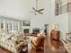 Living room with fireplace, high ceilings, hardwood floors, and natural light at 712 English Tudor Ln, Charlotte, NC 28211