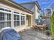 Outdoor patio seating area with grill and partial privacy fence and landscaping at 712 English Tudor Ln, Charlotte, NC 28211