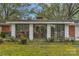 Rear view of the house showing a bright sunroom addition featuring three sliding glass doors at 725 Plantation Rd, Lancaster, SC 29720