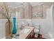 Stylish bathroom features decorative wallpaper, updated vanity, and well-appointed fixtures at 725 Plantation Rd, Lancaster, SC 29720