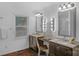 Bright bathroom featuring double sinks, mirrors with vanity lights, and wood flooring at 725 Plantation Rd, Lancaster, SC 29720