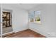 Bright bedroom with hardwood floors, white wainscoting, and large double windows at 725 Plantation Rd, Lancaster, SC 29720