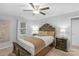 Cozy bedroom with a large bed, a ceiling fan, bedside tables with lamps, and a window with sheer curtains at 725 Plantation Rd, Lancaster, SC 29720