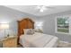 Cozy bedroom features a large decorative headboard, lamps, and a window at 725 Plantation Rd, Lancaster, SC 29720