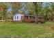 Charming brick home with a well-maintained lawn and mature trees providing shade at 725 Plantation Rd, Lancaster, SC 29720