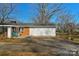 Single-story home with brick and white siding, a driveway, and well-manicured front yard at 725 Plantation Rd, Lancaster, SC 29720