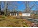 Charming single-story home with a brick and white exterior, set on a lot with mature trees and a spacious yard at 725 Plantation Rd, Lancaster, SC 29720