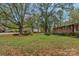 Lush front yard with mature trees, lawn, and beautiful landscaping at 725 Plantation Rd, Lancaster, SC 29720