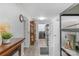 Hallway leading to the laundry with washer and dryer with white brick wall at 725 Plantation Rd, Lancaster, SC 29720