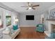 Cozy living room with hardwood floors, a decorative fireplace, large windows, and comfortable seating at 725 Plantation Rd, Lancaster, SC 29720