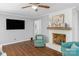 Cozy living room with hardwood floors, a ceiling fan, and white painted fireplace at 725 Plantation Rd, Lancaster, SC 29720