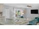 Open floor plan showing the granite kitchen island and the living room with a ceiling fan and flat screen television at 725 Plantation Rd, Lancaster, SC 29720