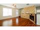 Living room with hardwood floors, fireplace, and kitchen views at 733 Jones Branch Rd, Fort Mill, SC 29715