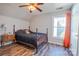 Bedroom featuring hardwood floors, ceiling fan, and natural light from the large window at 7505 Torphin Ct, Charlotte, NC 28269