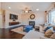 Cozy living room featuring a fireplace, hardwood floors, and natural lighting at 7505 Torphin Ct, Charlotte, NC 28269