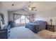 Spacious main bedroom with a vaulted ceiling, ceiling fan, large window, and neutral-toned walls and carpet at 7505 Torphin Ct, Charlotte, NC 28269