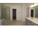 Modern bathroom with a large shower, double vanity, and grey tile floors at 8224 Annsborough Nw Dr, Concord, NC 28027