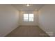 Simple bedroom with carpet and neutral wall colors at 8224 Annsborough Nw Dr, Concord, NC 28027