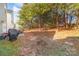 Spacious backyard with a patio featuring outdoor seating, a grill, and a peaceful wooded backdrop for privacy at 8411 Washoe Pine Ln, Charlotte, NC 28215